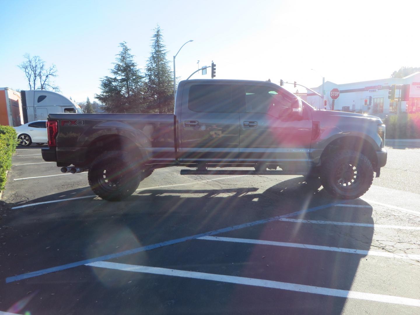 2019 CHARCOAL /BLACK Ford F-350 SD Lariat Crew Cab 4WD (1FT8W3BT7KE) with an 6.7L V8 OHV 16V DIESEL engine, 6A transmission, located at 2630 Grass Valley Highway, Auburn, CA, 95603, (530) 508-5100, 38.937893, -121.095482 - Leveled Superduty sitting on 20" XD series wheels, 35" Nitto Ridge Grappler tires, window tint, and has Firestone Air bags. - Photo#2